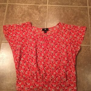 Red floral blouse with bow in back.